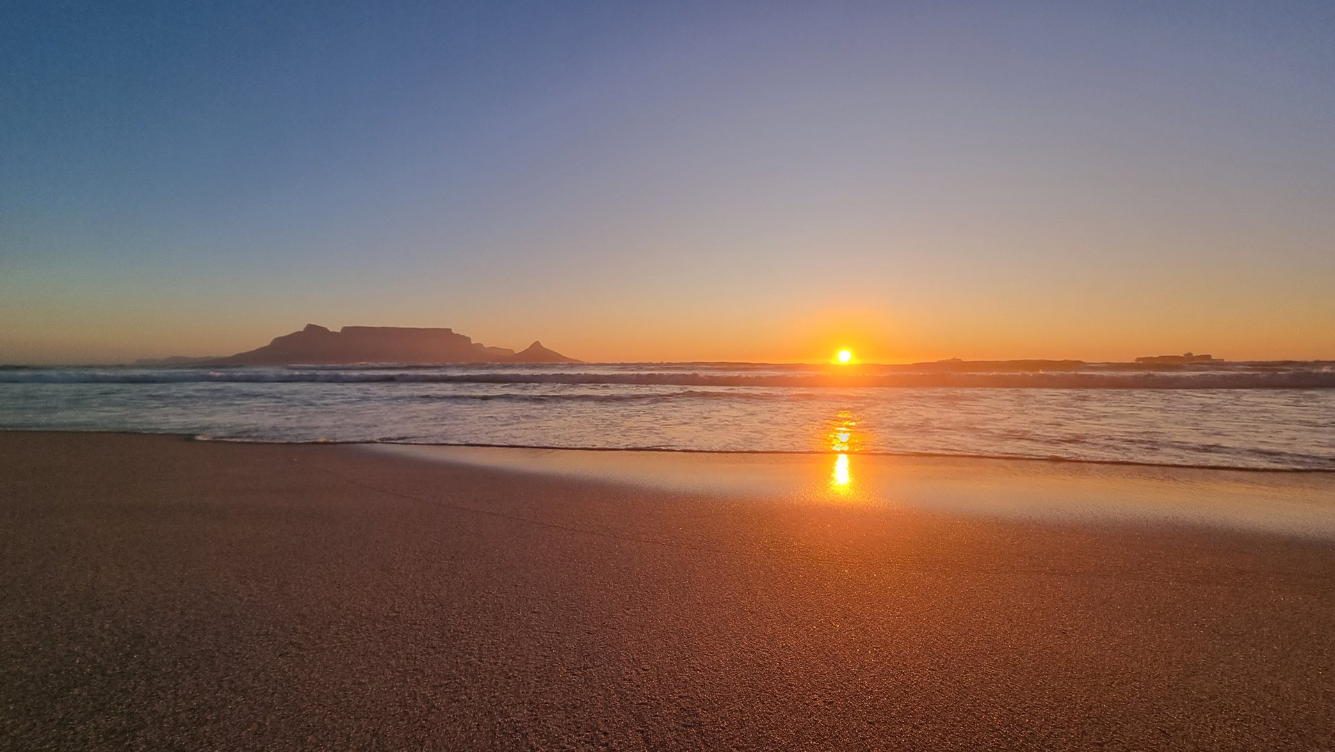 Sunset beside Table Mountain seen from Bloubergstrand beach across Table Bay