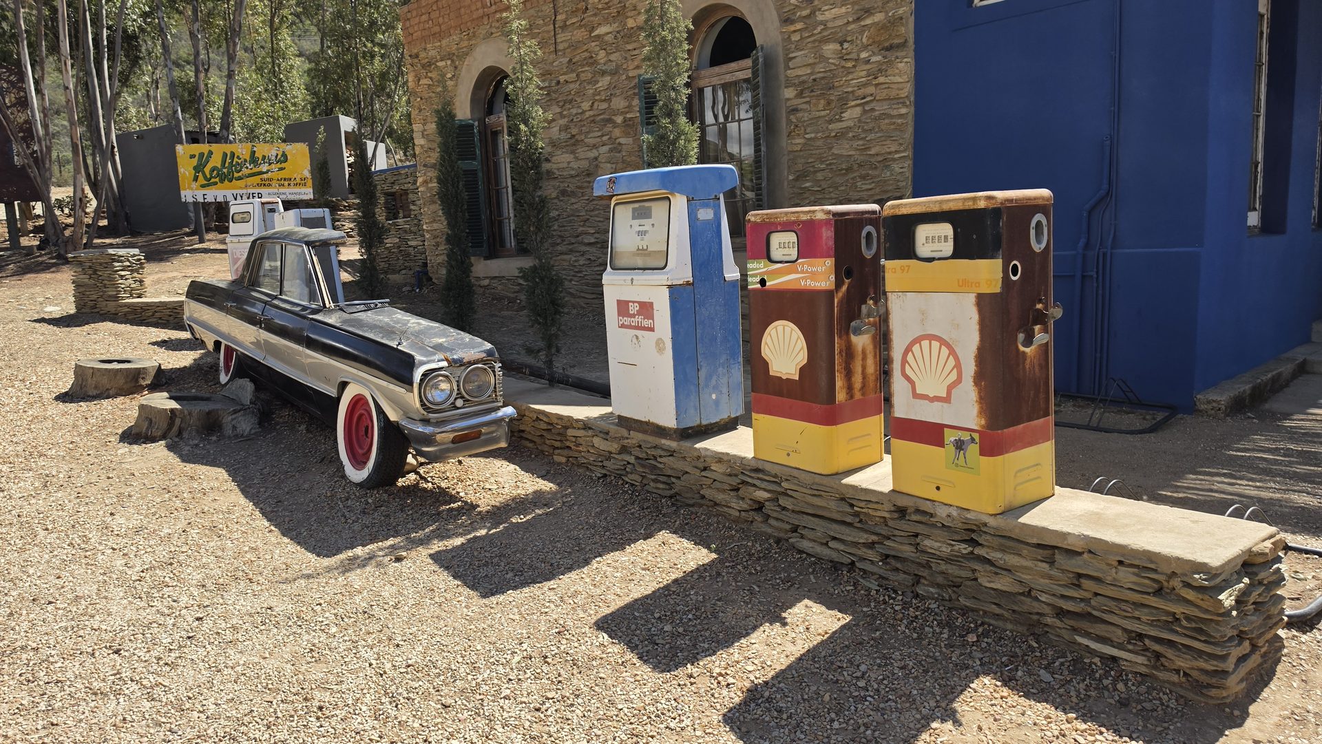 Vintage car and old petrol pumps at a classic Route 62 roadside stop
