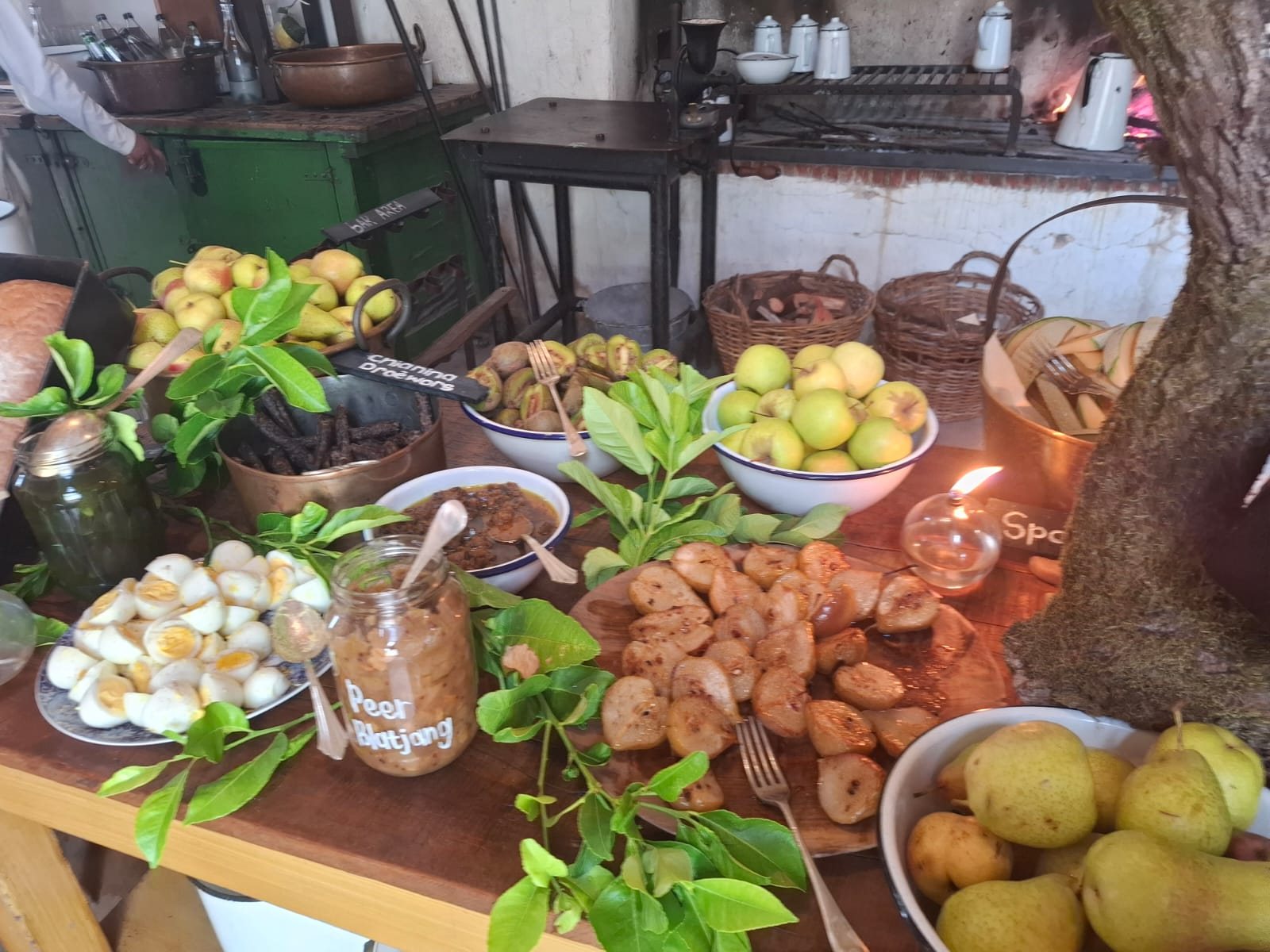 A rustic farm-to-table spread of bread, fruit and dishes at Soetmelksvlei