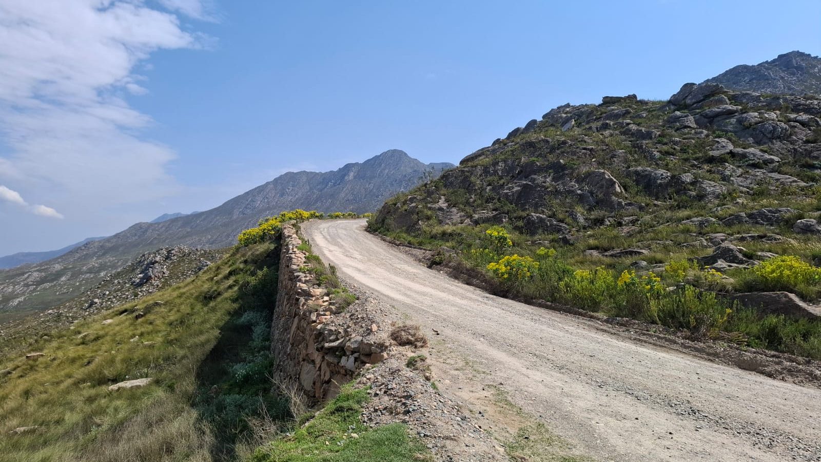 The Swartberg Pass gravel road lined by a hand-built dry-stone wall, Western Cape