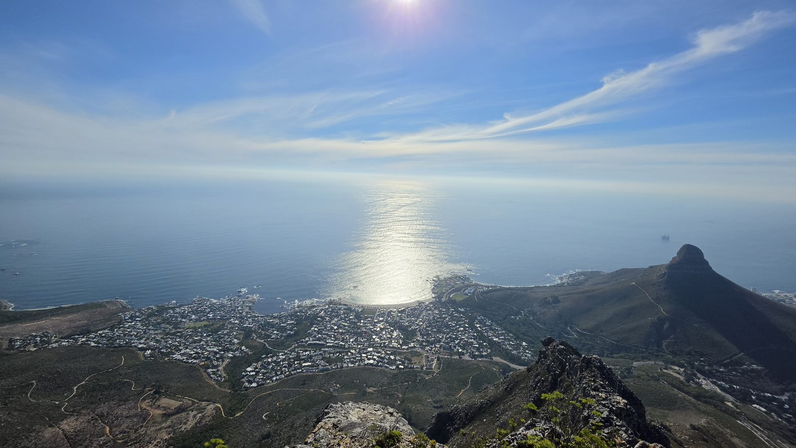 Afternoon sun over the Atlantic seen from Table Mountain with Lion's Head silhouette